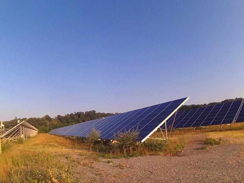 A large solar panel rests in a field.
