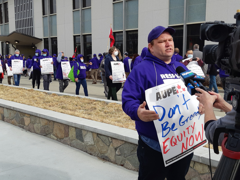 AUPE Local 052 Chair Justin Huesby speaks to the media at a U of C rally